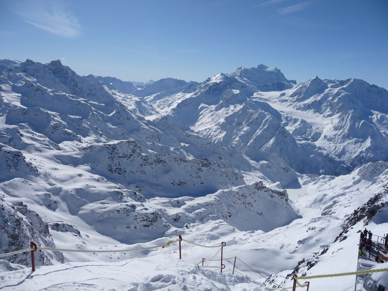 Snowy Verbier mountain landscape with ski lifts and a clear blue sky